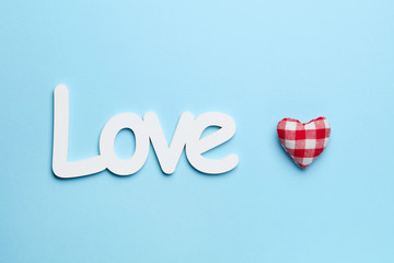 Plain blue background with red heart and white love sign