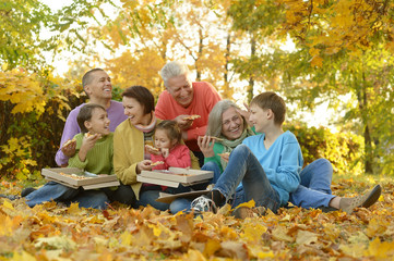 Family eating pizza in  park
