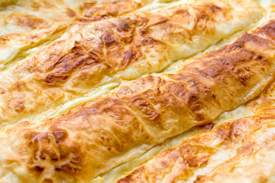 Traditional Serbian cheese pie gibanica closeup  in baking pan
