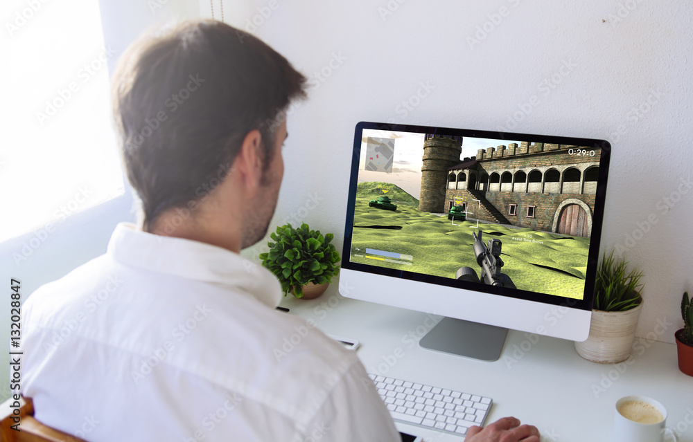 Poster man playing war videogame on computer