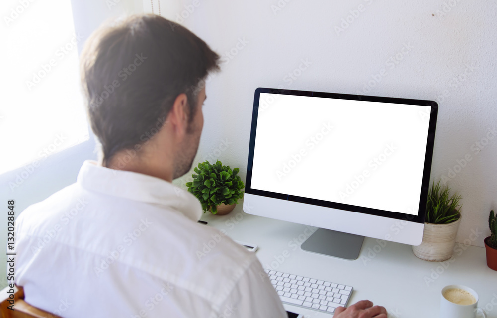 Wall mural man working white screen computer