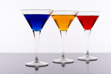 Colorful Cocktails in Martini Glasses Background. Bar Commercials Concept.