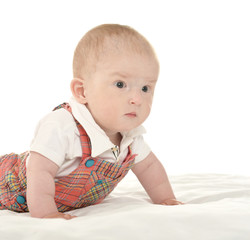 Baby boy crawling on blanket