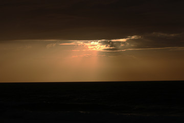 Beautiful sunset in winter, cloudy sky, sun ray in the sea of clouds