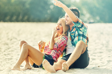 Love concept. Young couple enjoying sunny day on the beach.