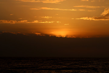 Very beautiful sunset in winter, cloudy sky, sun ray in the sea of clouds