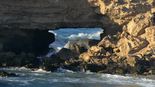 big waves braking in sandstone bridge cave 11115
