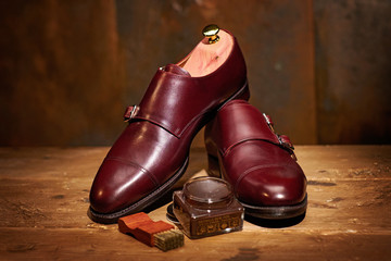 Still life with men's leather shoes and accessories for shoes care