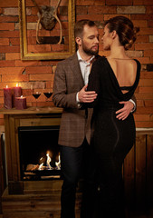 Well-dressed couple in cozy home interior