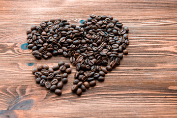 Coffee beans, grain two hearts on background of wooden , bagging. Valentine's Day or Wedding, love, black, frame. Big and small heart