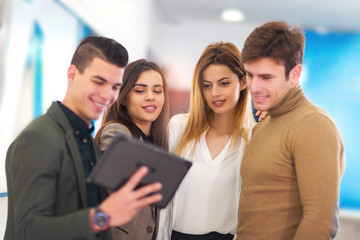 Fototapeta premium Four people are choosing digital tablet in store