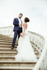bride and groom standing on stairs together