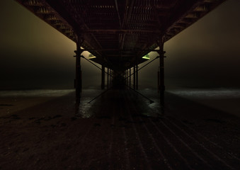 Paignton pier in mist at night