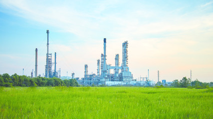 Oil refinery plant at sunrise with sky background