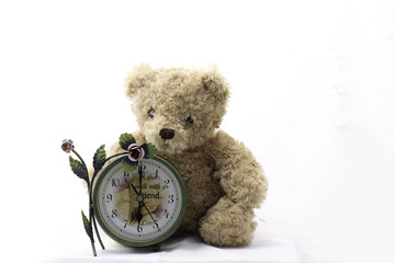 Teddy bears and clock on white background