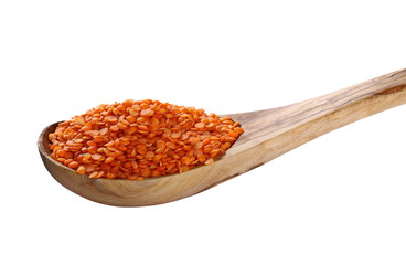 red lentils in wooden spoon isolated on white