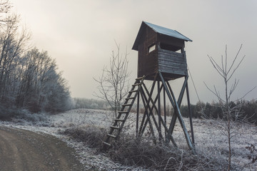 Hide by forest road. Winter rural landscape