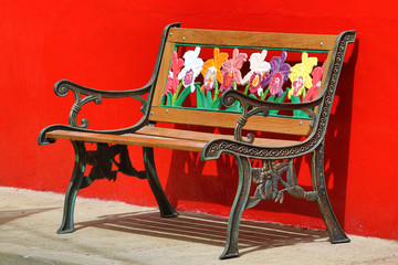 colourful bench against red wall
