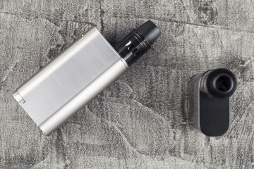 Vaping device on a concrete background.