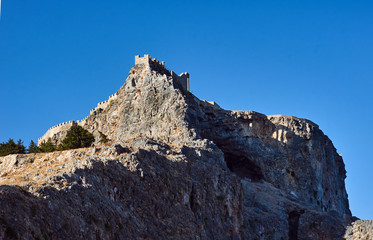 Fototapeta premium Medieval fortifications on top of the rock in Lindos .