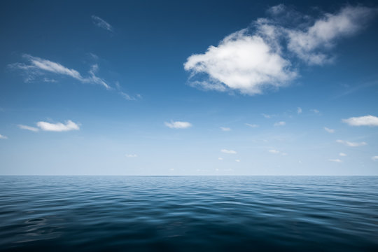 Calm Sea With Blue Clear Sky And Clouds