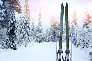 Afwasbaar fotobehang snowy cross country ski trail with retro wood skis and ski poles © ronstik