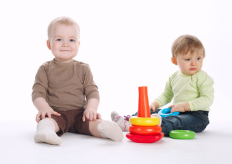 two beautiful children playing with pyramide