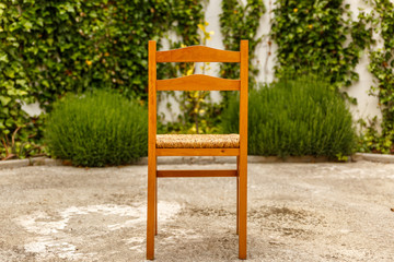 Fototapeta na wymiar Wooden and wicker chair on a patio