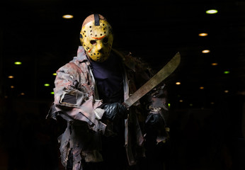 Man wearing mask with machete in the hand