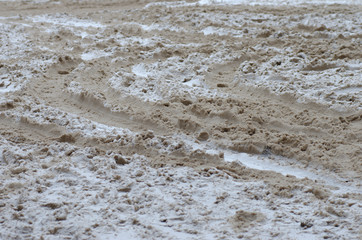 Fototapeta na wymiar Rut on dirty snow