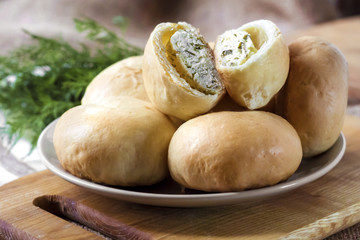 Pies with salty cottage cheese and greens