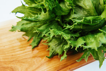 Wooden board with lettuce