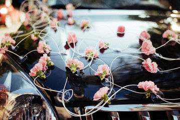 Wedding decoration on the hood of a car