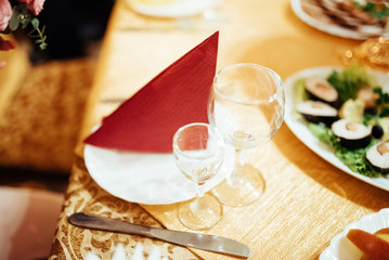 Formal stylish setting on a dinner table with elegant glassware