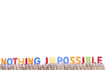 Man fingers showing "NOTHING IMPOSSIBLE" text on white backgroun