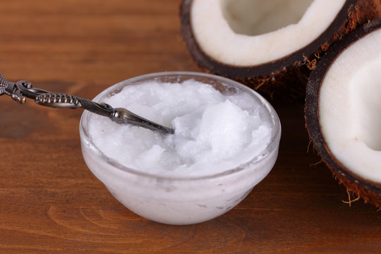 Coconut and coconut oil on brown rustic wooden background