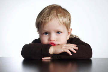 cute little bored boy on white background