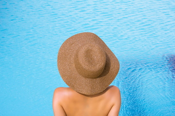 Fototapeta na wymiar Young woman relaxing at the pool
