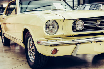 A closeup of the headlights and front bumper on a vintage automo