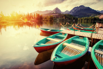 Boat on the dock surrounded mountains. Fantastic Shtrbske Pleso