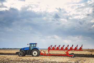 Fototapeta premium Tractor working in field