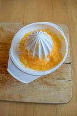 Orange juice squeezer on the wooden table