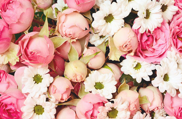 Closeup of pink roses and white daisy flowers bouquet