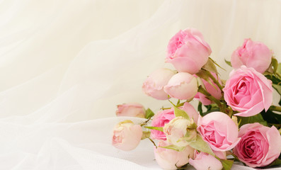 Rose flowers on white folded tulle