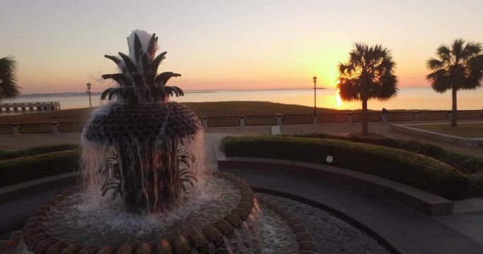 Rotating aerial perspective of the Pineapple Fountain at sunrise in Charleston, SC