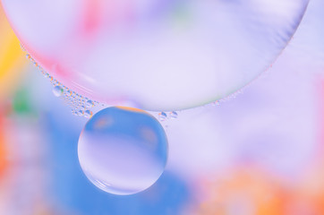 colored oil droplets on the water surface