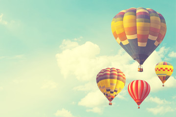 Naklejka premium Hot air balloon on sun sky with cloud, vintage and retro instagram filter effect style