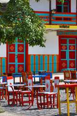 colourful cow hide chairs outdoors on coffee-shop patio in El Jardin Colombia