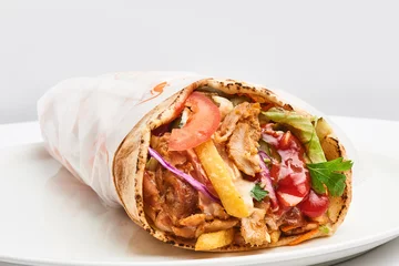 Abwaschbare Fototapete shawarma with sauce on white background.. © catalineremia
