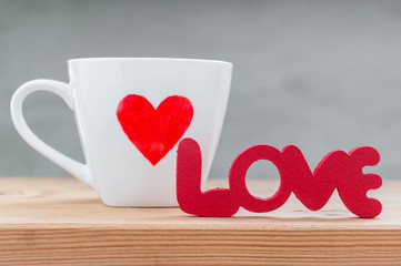 Words "Love" from wooden with cup of love  on wood table